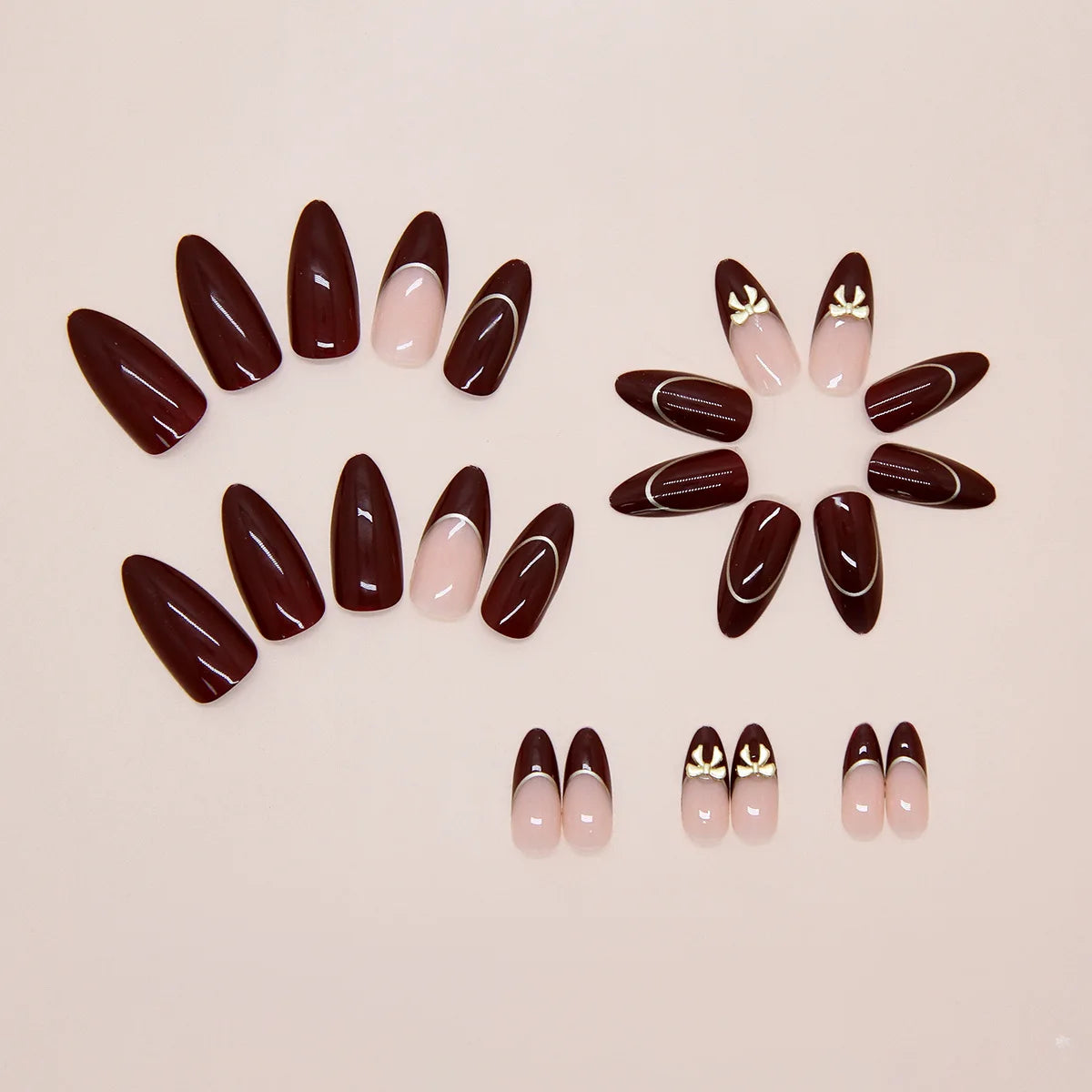24 handmade almond nails. Burgundy base with nude French, white lines & metal bows. Reusable, elegant retro style for daily wear